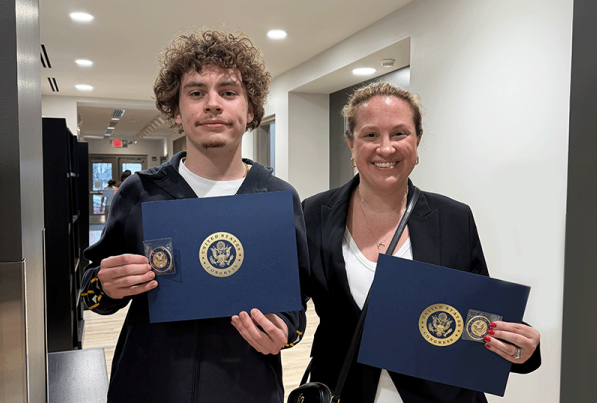 Brayden Buchman and his photagraphy instructor, Mrs. Rachel Houck stand with their Congressional Art Competition awards, at the Baum School of Art in Allentown.
